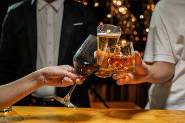 food and drink male friends are happy drinking beer and clinking glasses at a bar or pub.