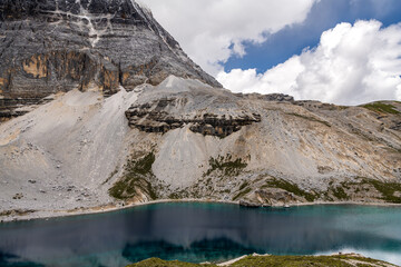 A Five colour lake landscape view; Snow mountain, crystal clear lake with a deep blue color, blue sky at Yading National Nature Reserver