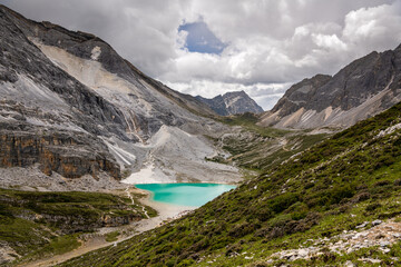 Milk lake at Daocheng Yading National park, Sichuan, China. Blue sky with dramatic white clouds, copy space for text, Last Shangri-la