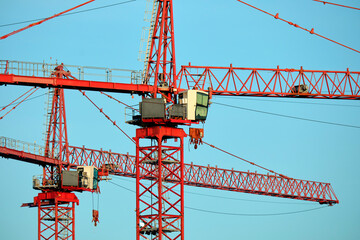 Tower lifting cranes at high residential apartment buildings construction site. Real estate development