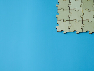 Complete wooden jigsaw puzzles business cooperation on a blue background