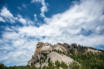 Mount Rushmore in the Black Hills of South Dakota against a cloudy sky.
