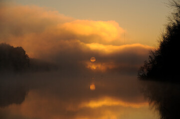 Fototapeta na wymiar beautiful sunrise on a lake with fog and geese