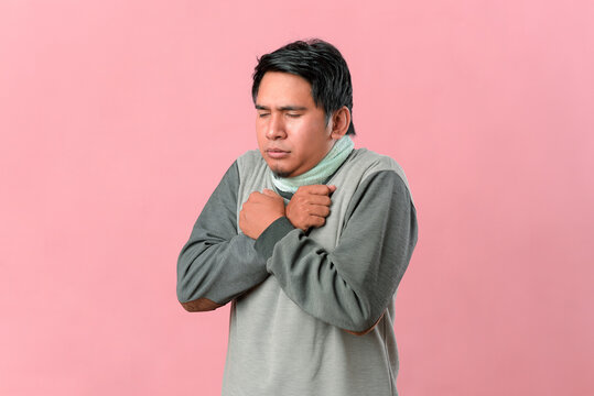 Portrait of Asian man shivering, trembling and feeling cold
