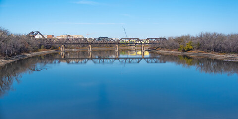 Fototapeta na wymiar Railway bridge over a rivewr in Winnipeg manitoba