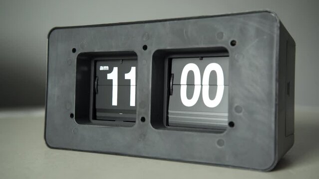 Flip clock shows it's 11 a.m. time