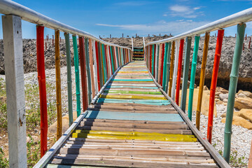 A colourful bridge leading over to an island at Hang Rai National Park in Vietnam