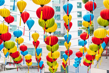 Looking up at rows of brightly coloured lanterns hanging  above on strings in Nha Trang, Vietnam