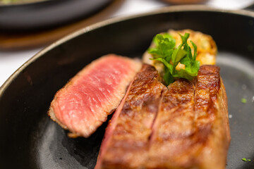 Juicy steak sliced on the plate in restaurant