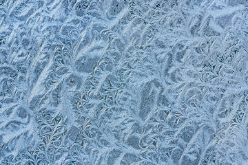 natural frosty pattern on winter window. ice crystals on glass. highly detailed view.