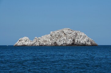 Fototapeta na wymiar The view of white rock island in the middle of the ocean near Mazatlan, Mexico