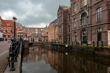 Fototapeta na wymiar Amsterdam canals and typical houses with a morning spring sky.