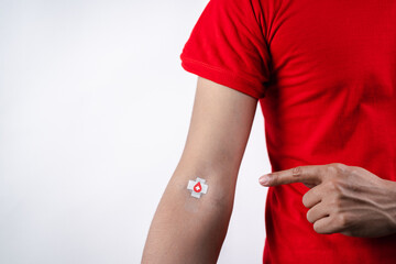 man showing plaster after donation blood, blood transfusion, world blood donor day, world...