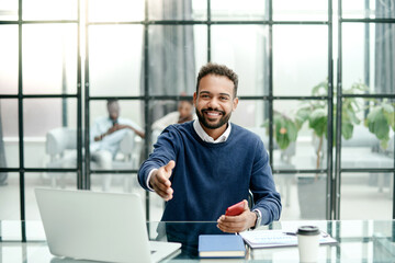 mature businessman reaching out for a handshake.