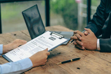 Hiring concept HR manager is interviewing a job candidate filling out a resume on a job application form to be considered for a job