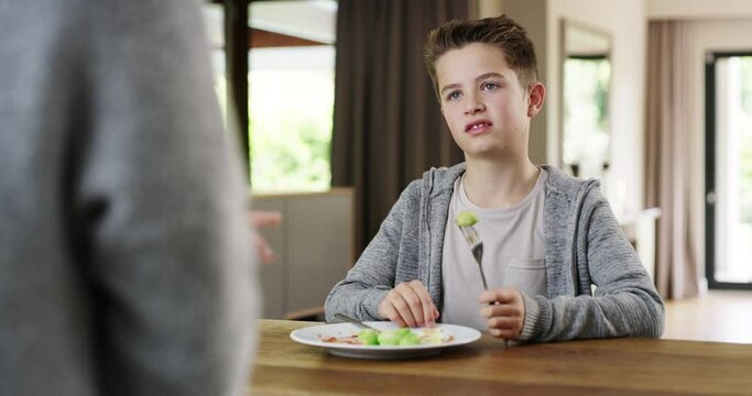 Food, Brussels Sprouts And Child With Dislike On Face Sitting At Table Eating Gross Disgusting Veggies. Vegetables, Nutrition And Unhappy Boy With Disgust For Healthy Vegetable Dinner With Mother.