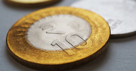 Indian coins lie on gray surface. 10 ten rupee coin close up. News about economy or finances of India. Reserve bank rate and external debt. National currency or finance. Horizontal stories. Macro