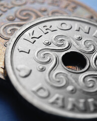 Danish coins. 1 Danish krone coin close-up. National currency of Denmark. Money vertical stories for news about economy or finance. Bank and loan. Savings and interest. Macro
