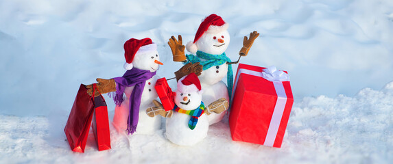 Christmas banner with snowman. Happy snowman with gift in winter snowy background. Winter holidays,...