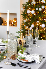 Light festive Christmas interior, set table for a festive dinner