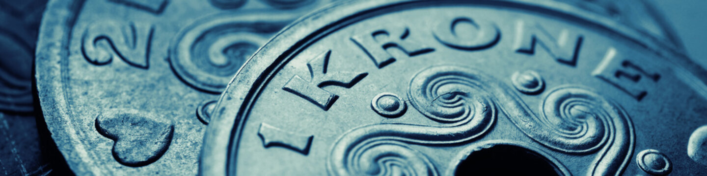 Danish coins. 1 Danish krone coin closeup. National currency of Denmark. Blue and green money banner or header for news about economy or finance. Loan and credit. Tax and inflation. Macro