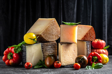 spanish manchego aged cheeses on rustic wooden table. banner, menu, recipe place for text