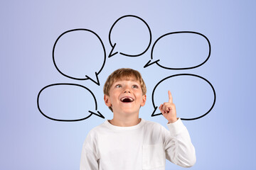 Happy boy with finger pointing up and copy space thought bubble