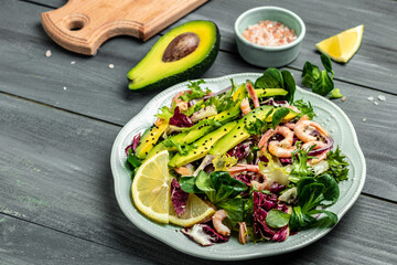 salad with fresh Avocado, Shrimps lettuce green mix and olive oil, lemon dressing. healthy food, Delicious breakfast or snack, Clean eating, dieting, vegan food concept. top view