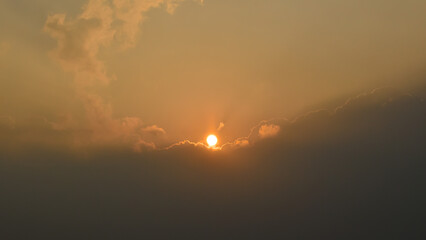 Dramatic sunset sky landscape background natural color of morning with setting sun rays coming through clouds ultra wide  view. Background of sky and sunrise.