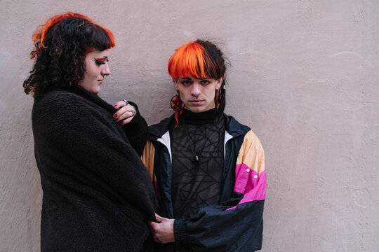 Portrait of a transgender couple with painted hair.
