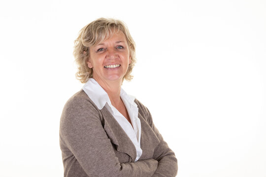 Middle age blond business woman standing happy face smiling with crossed arms on white background