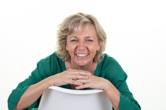 Smiling Cute Happy Mature Woman Senior Blond Sitting On White Background