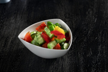 close up view of fresh vegetable salad on grey background