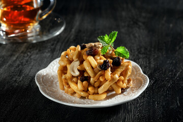 Close up view of dessert plate and cups on black background