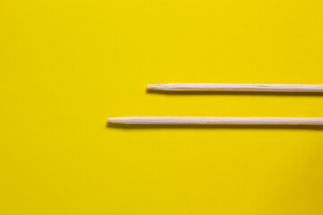 Bamboo chopsticks isolated on yellow background