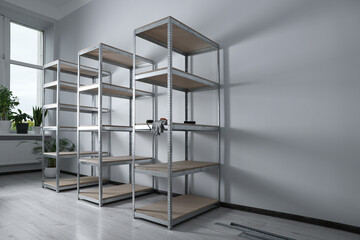 Office room with white walls and metal storage shelves - obrazy, fototapety, plakaty