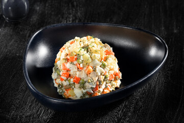 close  up view of nice yummy russian salad on dark back