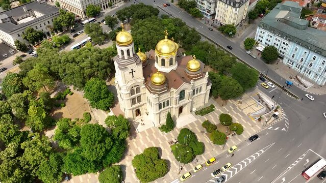 Cathedral in City center of Varna. Urban Landscape. Golden domes of the Assumption Cathedral. Aerial view. Descending drone flight around the Dormition of the Mother of God. Varna is the sea capital 