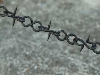 Beautiful black chain with spikes on grey background