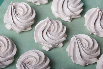 Homemade zephyr. White tray with marshmallows. Stands on black pine boards. Close-up.
