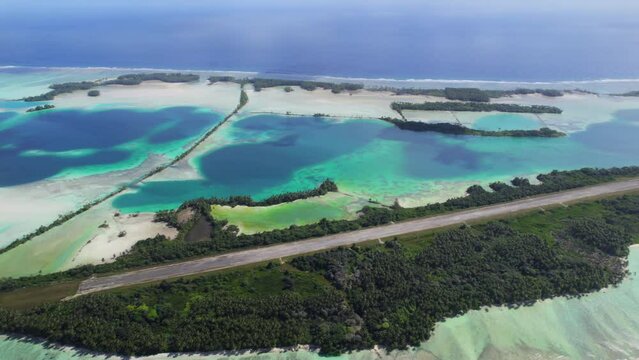 Aerial shot of man-made islands, runway, causeways and lagoon at Palmyra Atoll.
