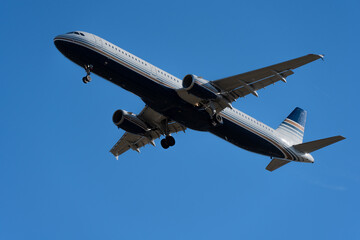 A large passenger plane takes off into a clear blue sky
