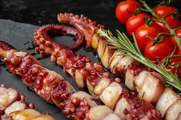 Delicious appetizer of squid and octopus tentacles in Asian style. Close-up.