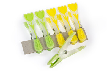 Set of plastic spring-type clothespins on a white background