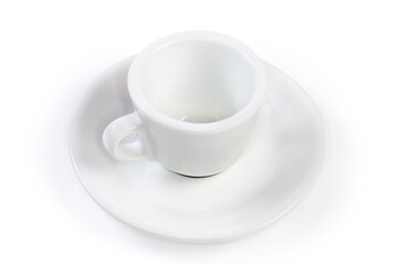 Small empty white coffee cup with handle on the saucer
