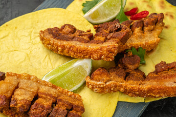 Slices of fried pork with a crispy crust on tortillas
