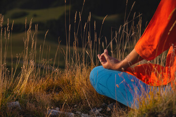 close-up of a woman's hand sitting in a meditation pose and holding mudra with fingers, yoga in the...