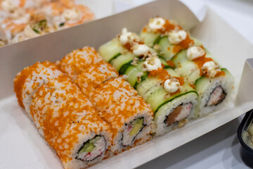 Rolls with flying fish roe, crab and cucumber. Japanese food from home delivery.