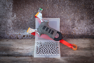 sports slingshot and metal balls on a wooden table, wooden background