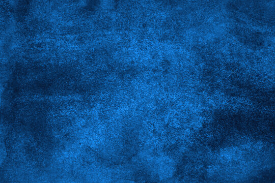 Dark blue abstract background with space for design. Navy color watercolor. Rough surface of painted paper. Macro.